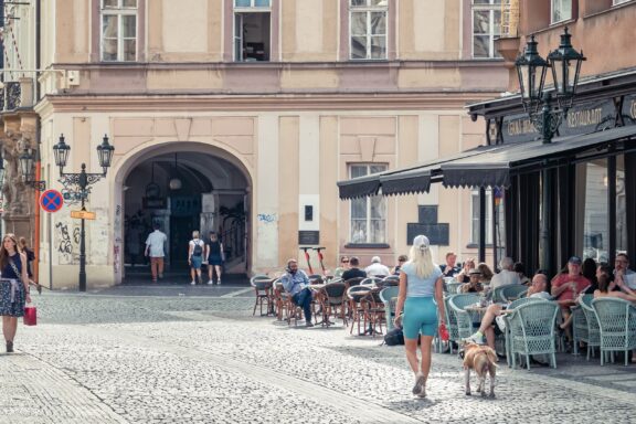 Cobblestone Street in Prague Old Town with Outdoor Café and Pedestrians Urban scene in Old Town Square in Prague
