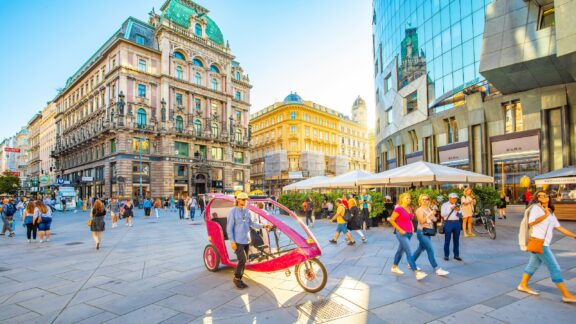 Bustling Street Scene in Vienna, Austria with Pedicab and Pedestrians People walk on Graben Street in Vienna, the capital of Austria.