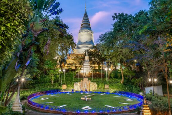 Illuminated Wat Phnom Temple at Twilight Fountains near the Wat Phnom