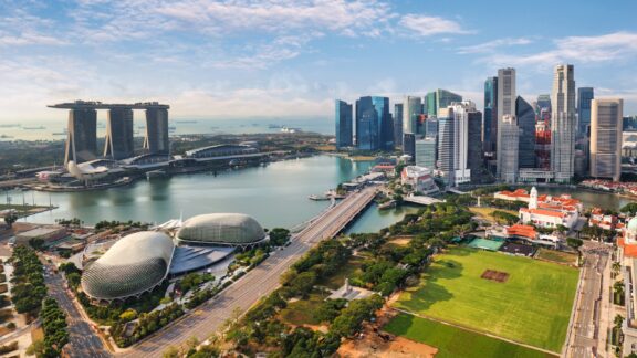 The Marina Bay Sands building and Singapore skyline during a sunny day. 