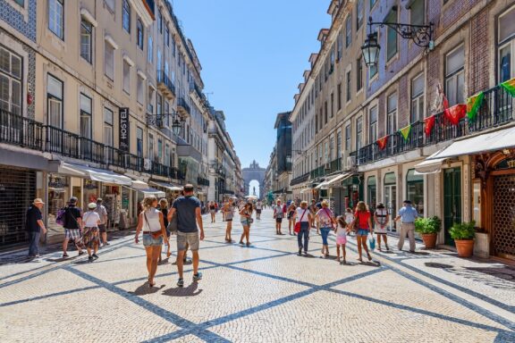 People stroll through Augusta Street, located in the Baixa neighborhood