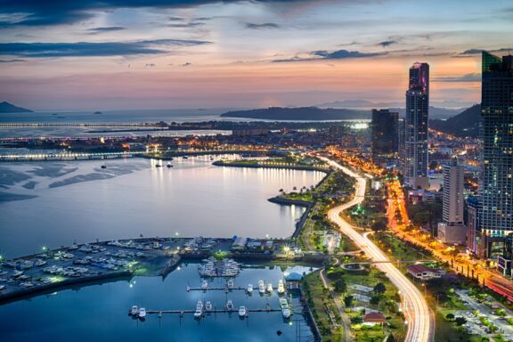 Panama City at dusk next to the Panama Canal. 