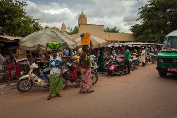 Bustling Street Scene with Locals and Motorbikes Busy streets with locals and vendors selling goods in Bamako
