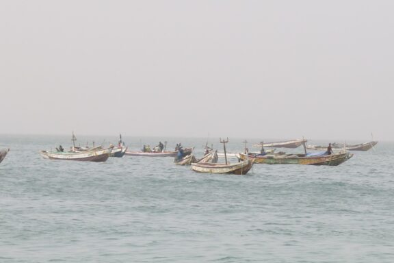 Fishing Boats on Hazy Sea Traditional wooden fishing boats near the Plage de Nouakchott