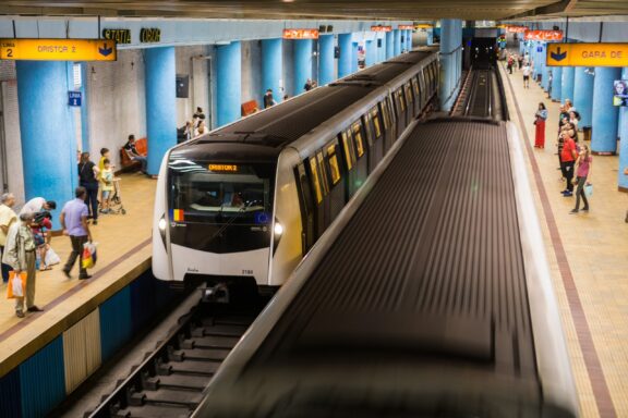Train Arriving at Busy Metro Station Platform The Bucharest Metro, inaugurated on November 16, 1979