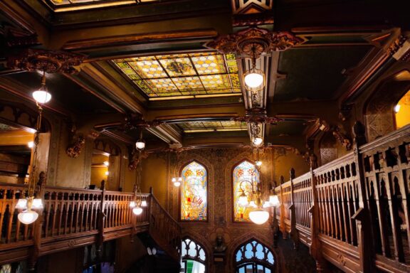 Interior of a Traditional Pub with Stained Glass and Wooden Decor Caru' cu Bere, one of the oldest and most iconic restaurants in Bucharest.