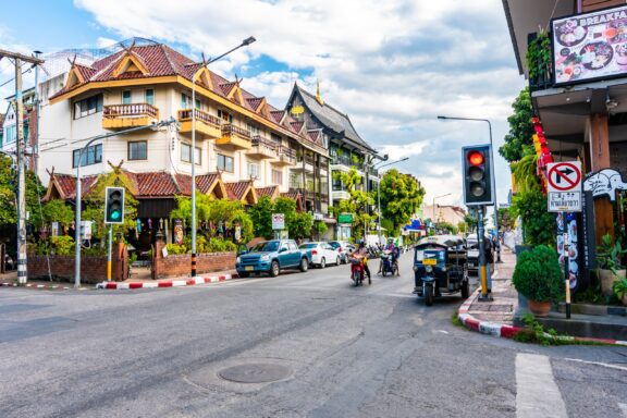 People on motorbikes wait at an intersection in Chiang Mai, Thailand. 