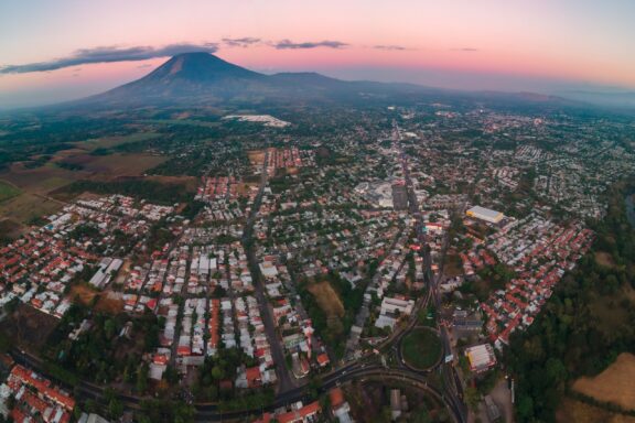 Aerial View of San Miguel City at Dusk with Volcano in the Background city of san miguel, el salvador with chaparrastique volcano in the background at morning from aerial view
