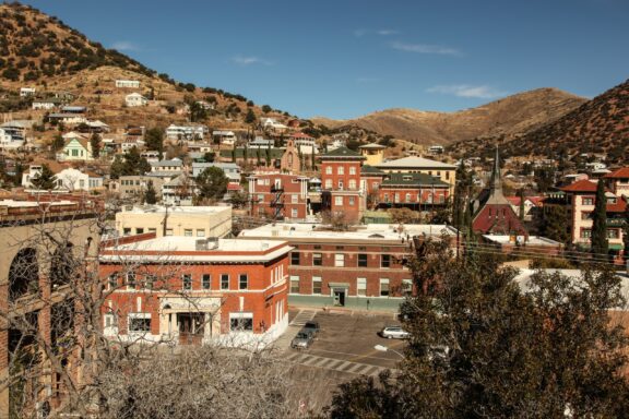 A view of buildings and hills in Bisbee, Arizona from a nearby hill.