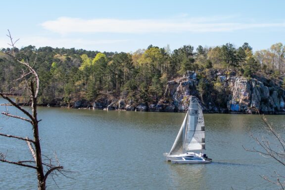 A sailboat floats on Lake Martin on a clear day in Coosa County, Alabama.