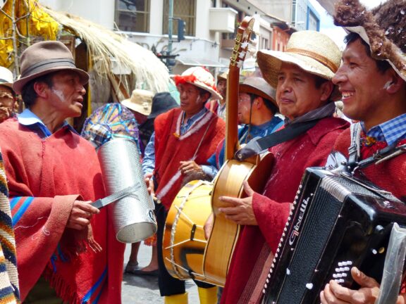 A group of musicians from an Indigenous community play instruments in Cuenca, Ecuador. 