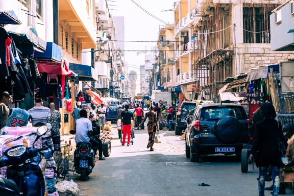 Locals commute through the busy streets filled with shops in Daka