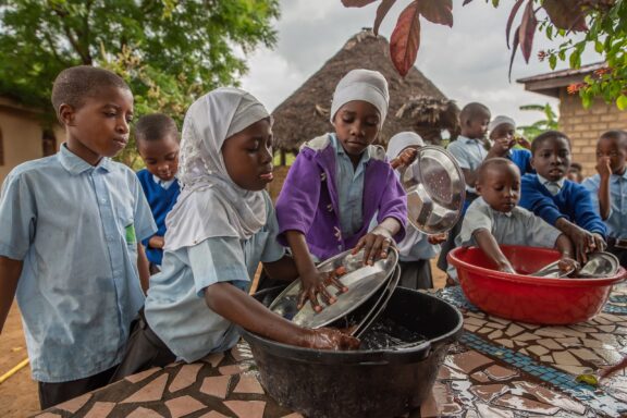 Schoolchildren Washing Dishes Outdoors Children in the school of Dodoma