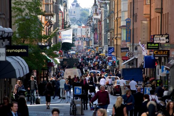 Bustling City Street Scene with Pedestrians People stroll through the pedestrian-only street of Drottninggatan