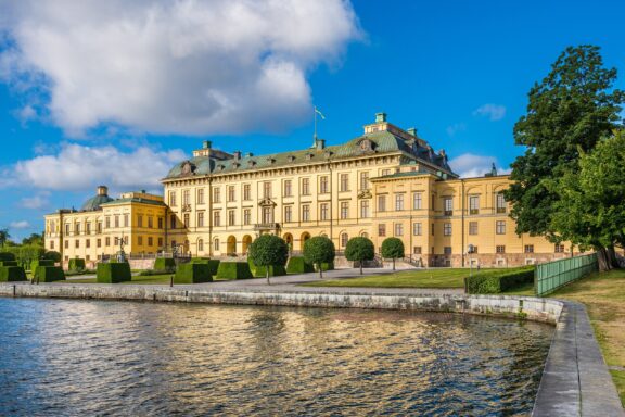 Drottningholm Palace by Waterfront Drottningholm Palace, private residence of the Swedish royal family