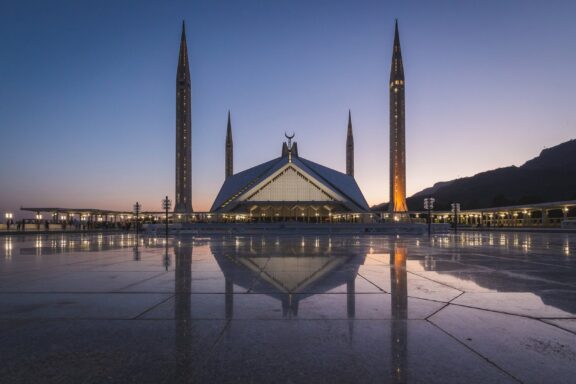 Faisal Mosque at Dusk with Reflection Faisal Mosque, strategically located at the northern end of Faisal Avenue