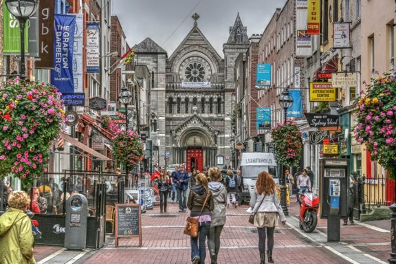 Bustling City Street with Pedestrians and Historic Architecture eople strolling through Grafton Street, Dublin