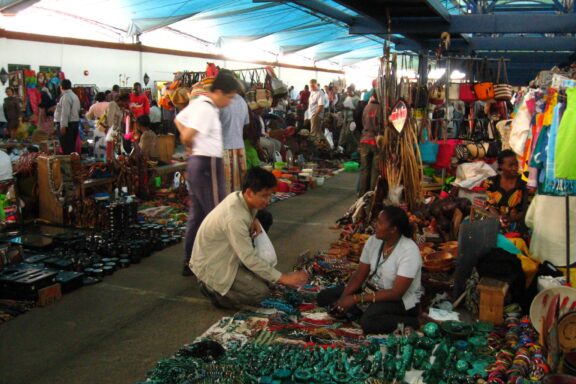 Vendors and Shoppers at a Busy Outdoor Market Local Nairobian artisans portraying Kenyan arts and crafts in the Maasai Market