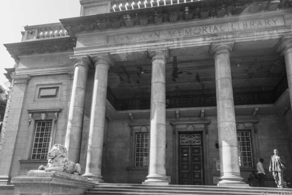 Black and White Photo of Historic Library Entrance with Columns and Lion Statue The Macmillan Library, recognized as one of Kenya's oldest and most extensive libraries