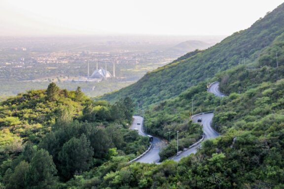 Scenic View of Winding Road in Margalla Hills with City in the Distance Margalla Hills, home to a wide variety of plant and animal species