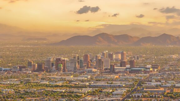 A view of downtown Phoenix, Arizona in the distance at dusk.