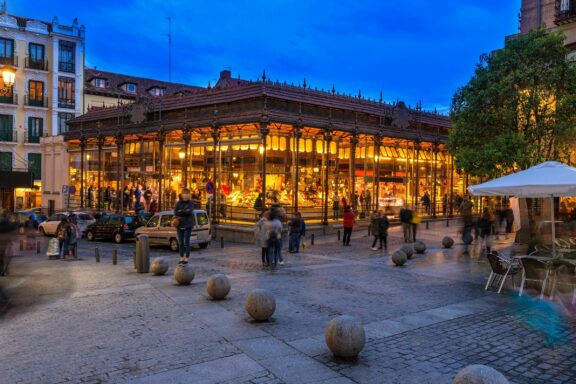 Twilight View of a Bustling Market Hall The Mercado de San Miguel, one of the most popular markets in Madrid