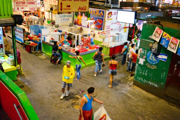 Indoor Market Scene with Stalls and Shoppers Locals strolling through Mercado Roberto Huembes