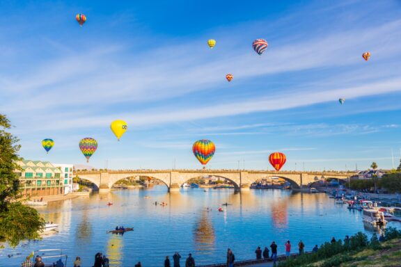 Hot air balloons float over London Bridge in Lake Havasu City, Arizona.