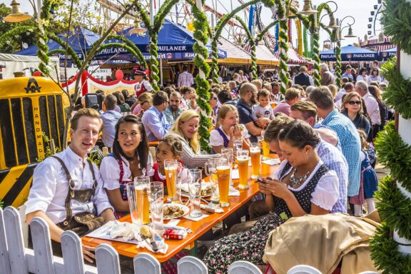 People sit at a table with beer during Oktoberfest in Munich, Germany.