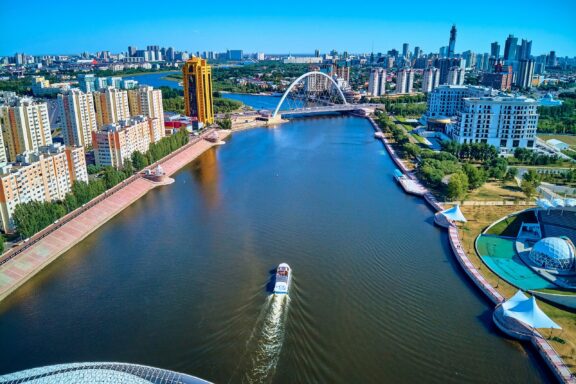 Aerial View of Nur-Sultan Cityscape with River Landscape of Nur-Sultan and Isham River on a sunny day