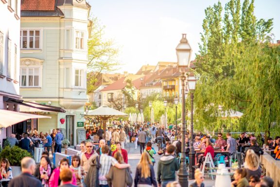 Crowded streets filled with cafes and restaurants, a vibrant and popular hangout scene in Ljubljana