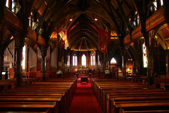 Interior View of Old St. Paul's Cathedral with Pews and Stained Glass Windows Interior of the Old St. Paul's