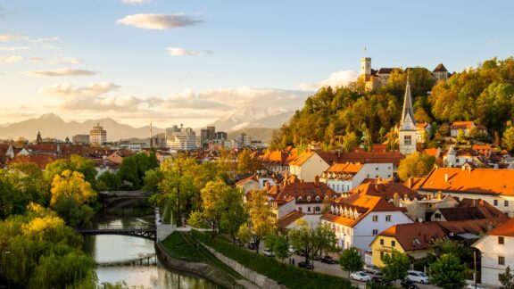 Buildings in the late-afternoon sun next to a river in Ljubljana, Slovenia.