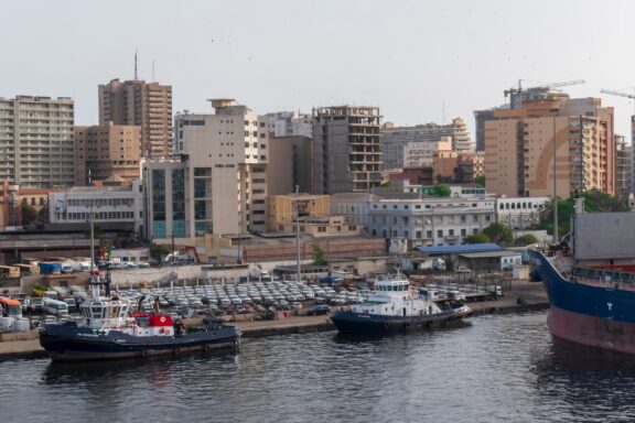 Port of Dakar with Moored Boats and City Skyline The Port of Dakar, the primary gateway for international trade in Senegal