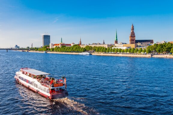 Tourist Boat on Daugava River in Riga Boat on the Daugava River and Riga in the background view