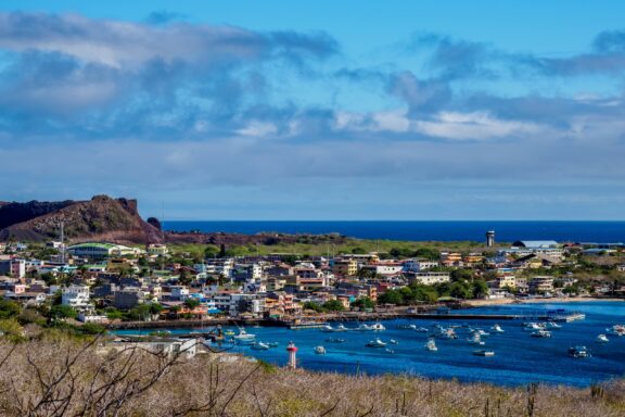 A view of Puerto Baquerizo Moreno, the capital of San Cristóbal, and boats in the water.