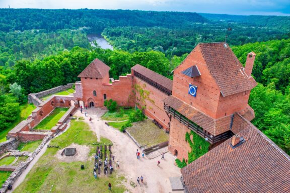 Aerial View of Sigulda Medieval Castle Amidst Green Forest Turaida Castle, the Sigulda New Castle, and the ruins of the Sigulda Medieval Castle