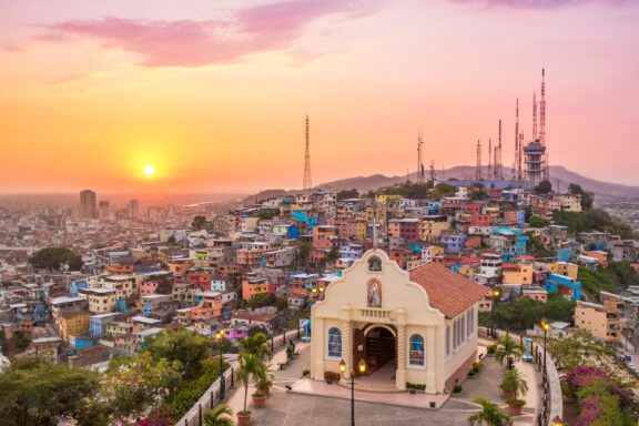 A pink and orange sunset over the city of Guayaquil in Ecuador. 