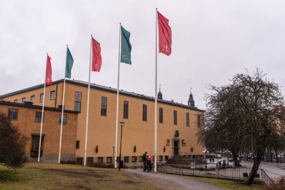 Flags in front of Swedish Museum Building The main entrance to the Swedish History Museum