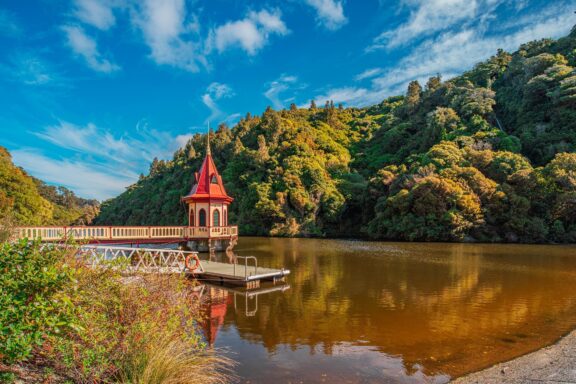 Scenic View of a Lake with a Red Roofed Dock House Zealandia, massive submerged continent that spans an area of about 4.9 million square kilometers