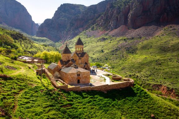 The Noravank Monastery sits between steep hills in Armenia. 