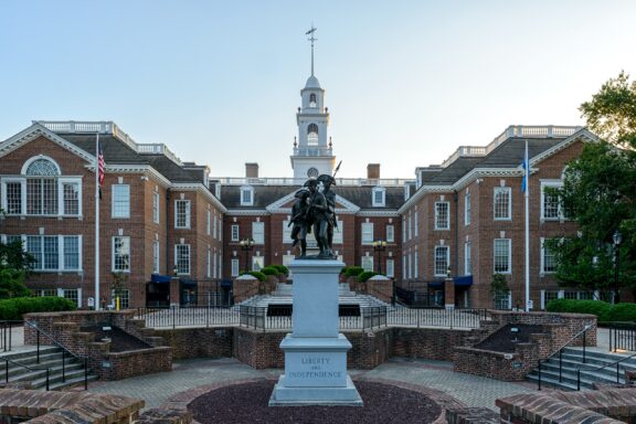 Statue in Front of the Kent County Courthouse in Delaware During Daylight A statue of three men stands outside the capitol building in Dover, Delaware.