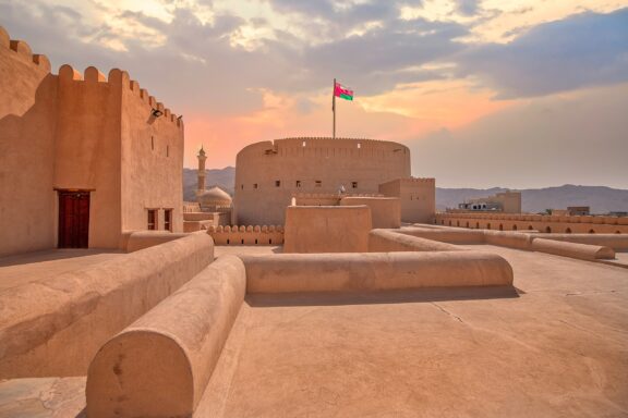 The Omani flag flies atop Fort Nizwa in Oman, one of the oldest countries in the world.