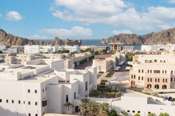 Traditional white buildings along Muscat's landscape