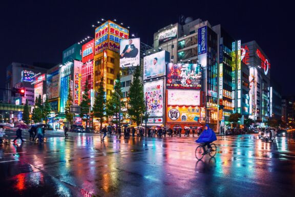 Neon Lights and Rain in Akihabara at Night Akihabara, known for its many electronics shops