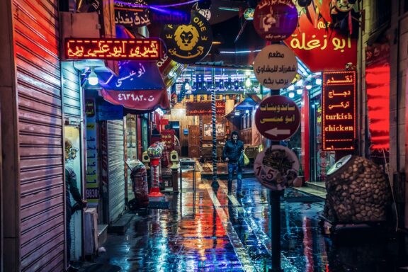 Narrow Alley in Amman at Night with Neon Signs Narrow Alley in Amman, filled with local restaurants and shops