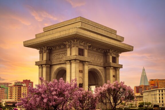 Arch of Triumph at Dusk with Blooming Trees Arch of Triumph, inspired by the Arc de Triomphe in Paris