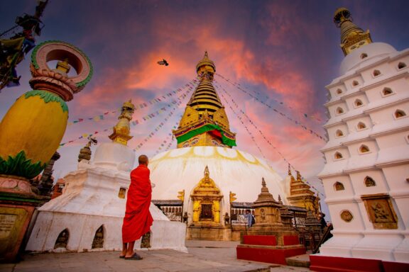Monk Observing Sunset at Boudhanath Stupa Boudhanath Stupa, one of the largest of its kind in the world