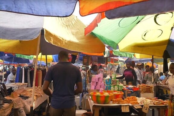 Bustling Market Scene Under Colorful Canopies Open-air market in Brazzaville
