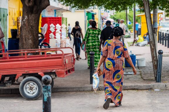Pedestrians Walking on a Street in Brazzaville Pedestrians stroll through streets of Brazzaville